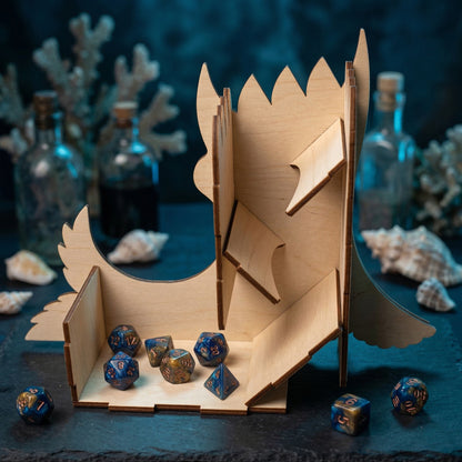 Internal view of a sea monster dice tower made of laser cut plywood, showing three angled ramps for rolling polyhedral dice. The light wood construction reveals the internal mechanism and the large landing tray filled with D&D dice.
