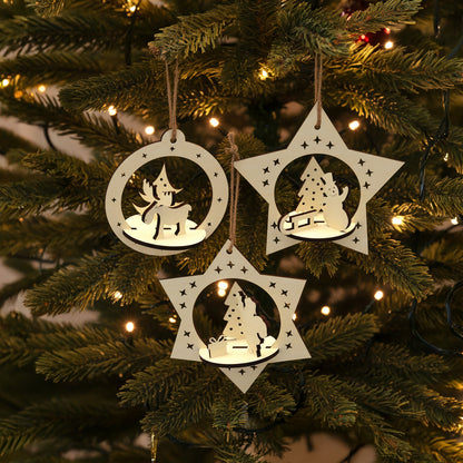 Delicate laser cut Set of 3 Christmas toys with intricate pop-out holiday figures of deer, snowman and Santa in hanging star-shaped frames, set against a twinkling Christmas tree background.