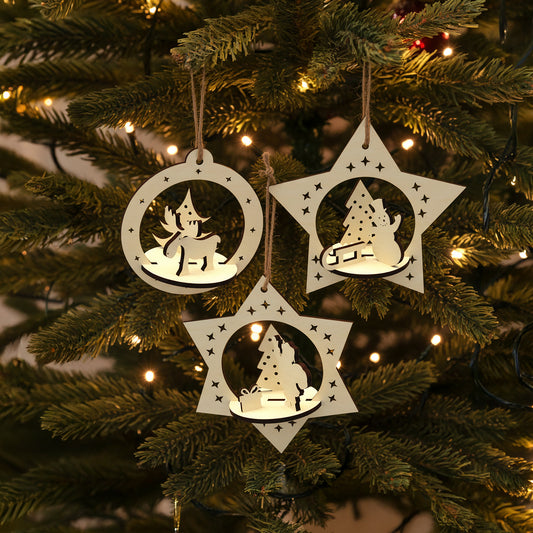 Delicate laser cut Set of 3 Christmas toys with intricate pop-out holiday figures of deer, snowman and Santa in hanging star-shaped frames, set against a twinkling Christmas tree background.