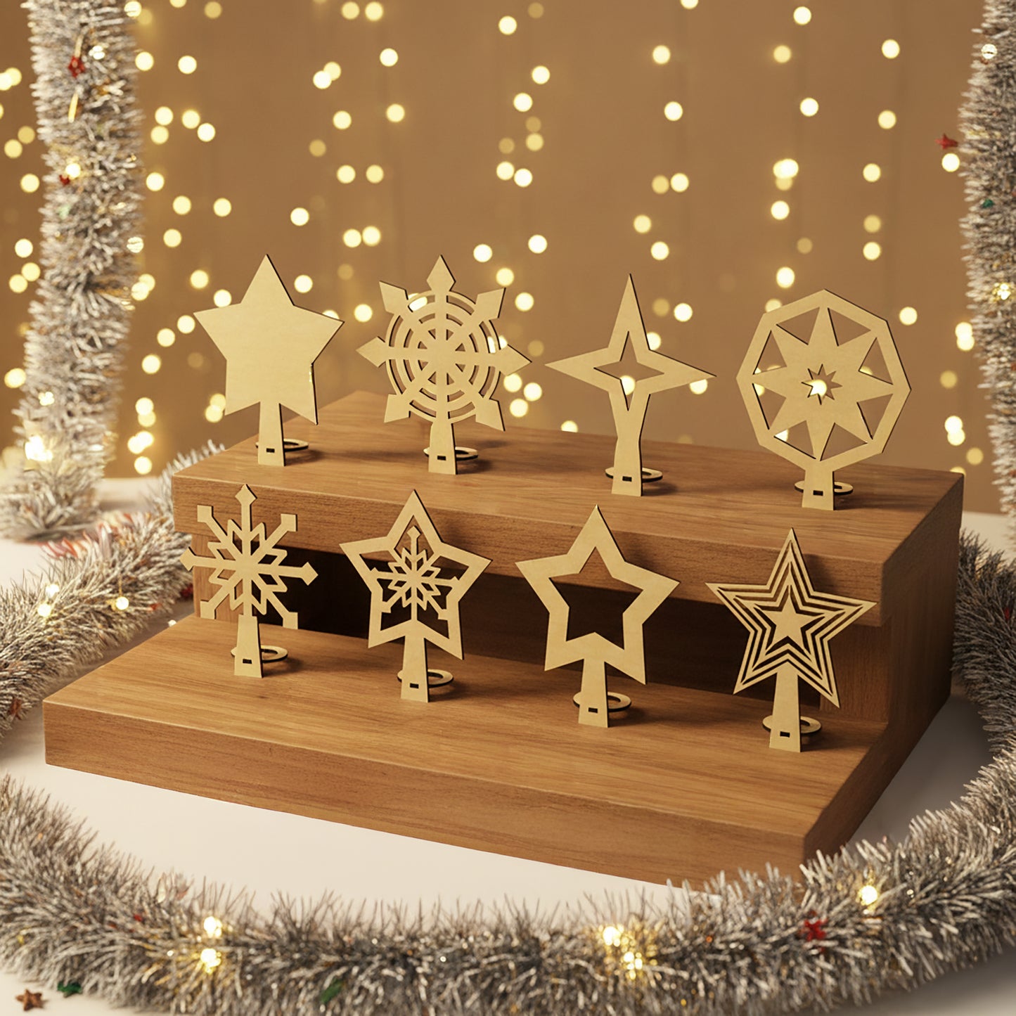 Set of 8 unpainted wooden laser cut Christmas tree toppers in assorted star and snowflake patterns with stands, arranged on a wooden riser against a warm golden bokeh background.