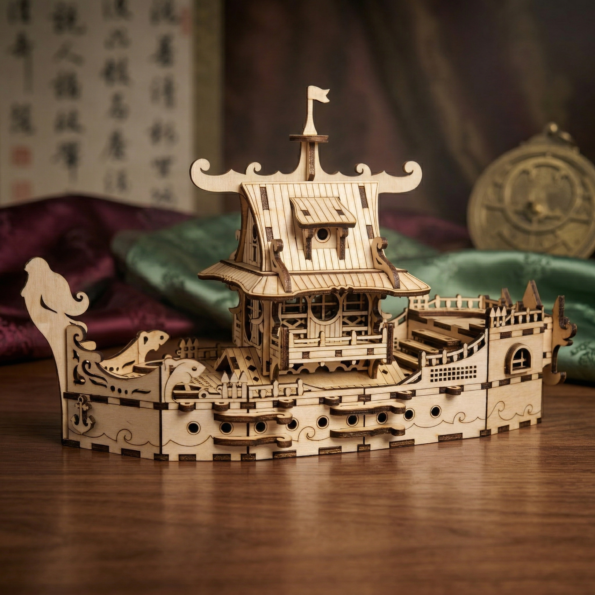 Wooden laser cut ship model on a wooden surface with a blurred background