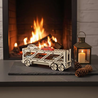 Laser cut wooden plywood car hauler truck 3D model carrying small colorful toy cars on a slate mat. Detailed two-tier plywood transporter puzzle. Cozy background with a roaring fireplace, a lantern, and pine cones.
