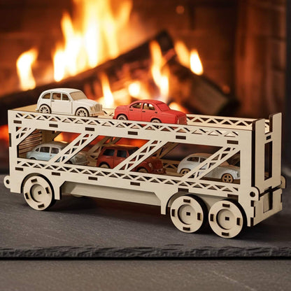 Laser cut wooden plywood car hauler truck 3D model carrying small colorful toy cars on a slate mat. Detailed two-tier plywood transporter puzzle. Cozy background with a roaring fireplace, a lantern, and pine cones.