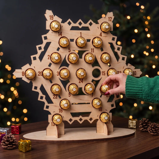 Hand takes chocolate treat from freestanding laser cut plywood snowflake advent calendar beside festive lights