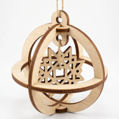 3D laser cut plywood spherical bauble featuring an internal suspended geometric star ornament on white backdrop
