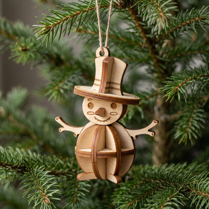 Laser cut plywood snowman ornament with top hat on white table next to evergreen pine branch, red berries, and fairy lights.