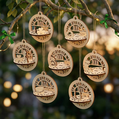 Seven handcrafted wooden St. Patrick's Day ornaments displayed on a tree branch. These 3D laser-cut plywood circles highlight various Irish symbols like a horseshoe, a leprechaun, and shamrocks. The natural wood grain and dark burnt edges are visible against a soft, sunlit garden background.