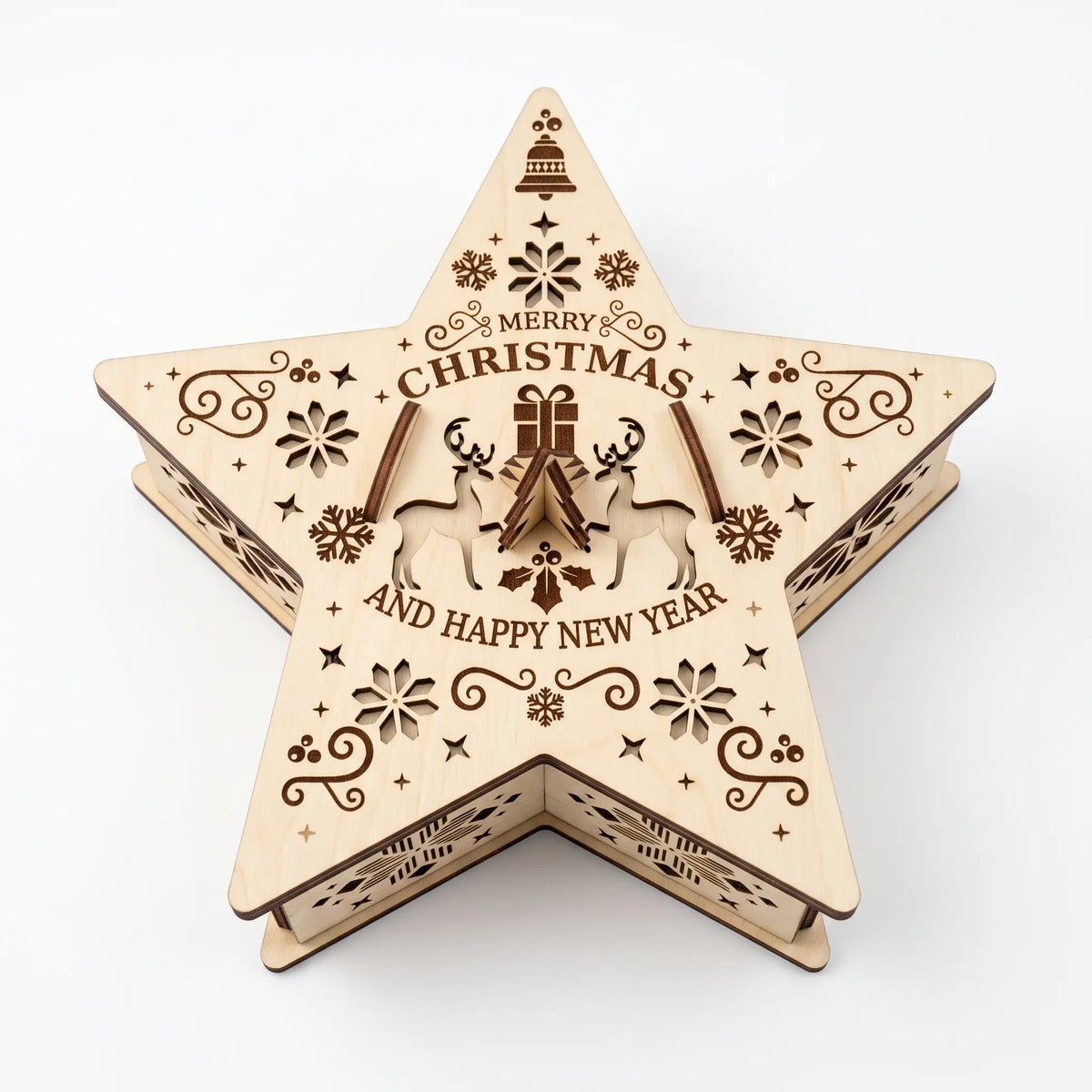 Top-down view of laser cut plywood star shaped gift box showing engraved Christmas greeting on white.