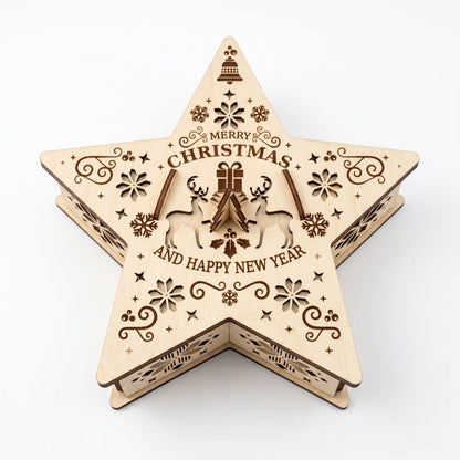 Top-down view of laser cut plywood star shaped gift box showing engraved Christmas greeting on white.