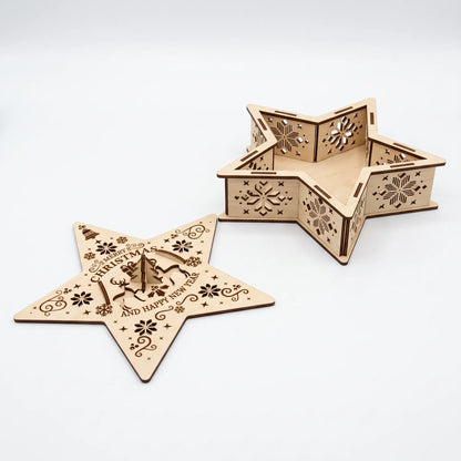Open empty laser cut plywood star box with removed lid showing intricate snowflake cutouts on white.