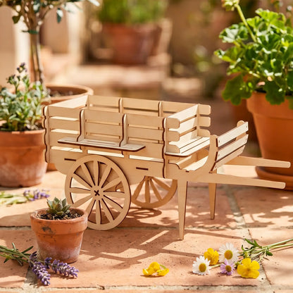 Wooden sweet cart laser cut model on a patio with potted plants and flowers