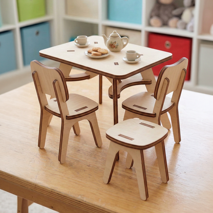 Dollhouse furniture wooden laser cut table and chairs set with tea set on a light wood floor.