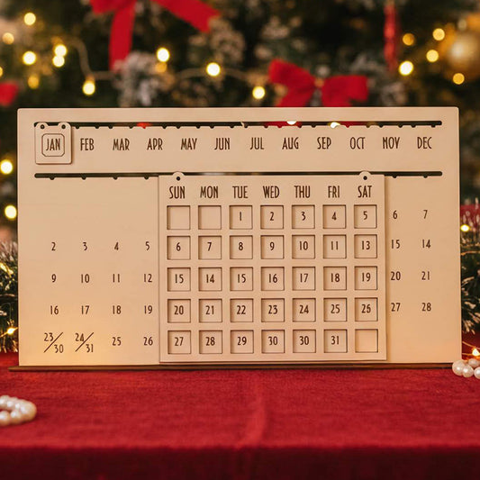Laser cut wooden The Eternal Calendar with sliding month and day blocks for perpetual use, displayed against a warm Christmas tree bokeh background.