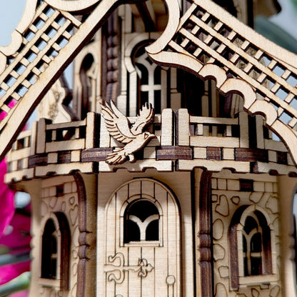 Extreme close-up view of a small engraved flying bird emblem attached to a decorative laser cut plywood windmill deck.