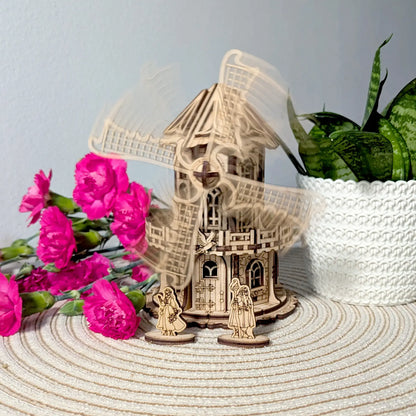 Action motion blur photo showing the functional blades spinning on an assembled laser cut plywood mechanical windmill.