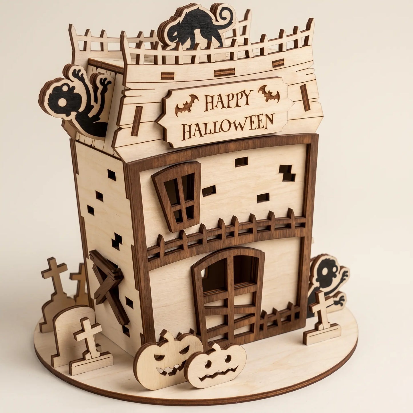 Detailed view of a laser cut plywood zombie house for Halloween, featuring a black cat and "Happy Halloween" sign.