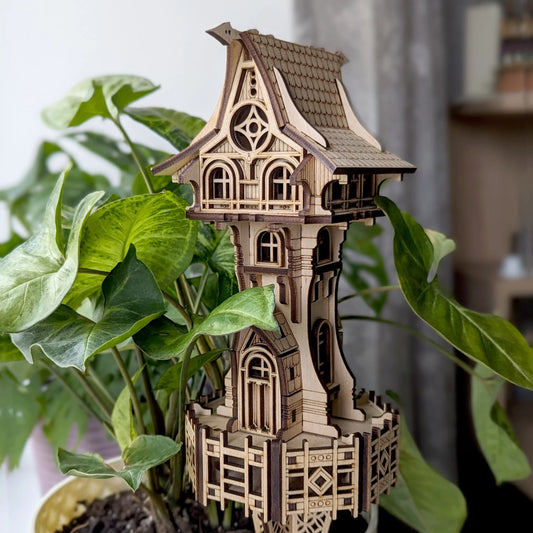 Laser cut plywood miniature fairy tower decorated with dark brown engraved accent lines.