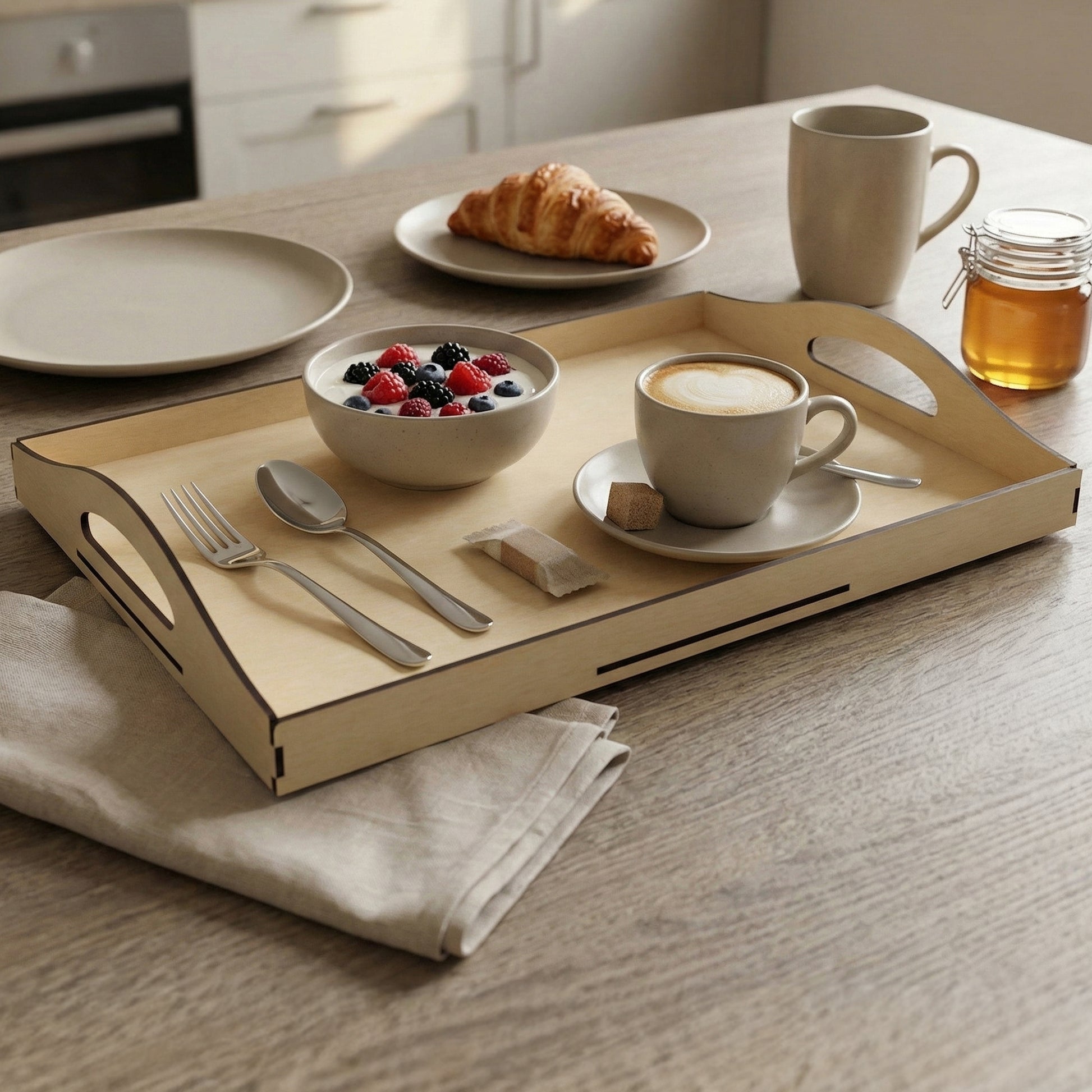 Natural wood laser cut serving tray with integrated handles, holding breakfast items like yogurt with berries and coffee, on a bright kitchen table background.