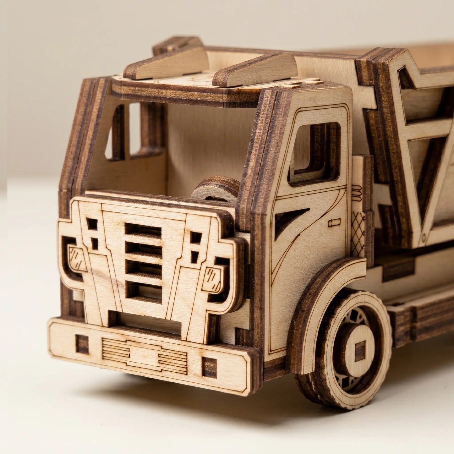 Wooden model of a truck on a light gray background