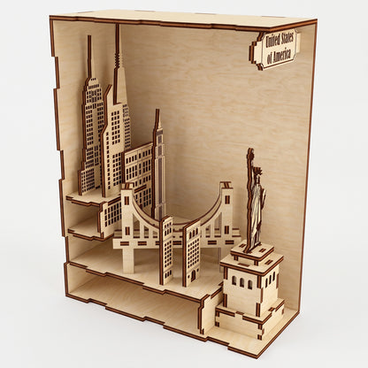 Open-view of a laser-cut birch plywood USA book nook showing architectural layers, the Statue of Liberty, and a top text sign.