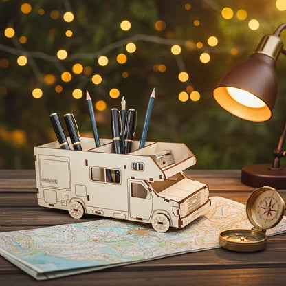 Wooden laser cut camper van pen holder with pencils on a table with a map and lamp in the background