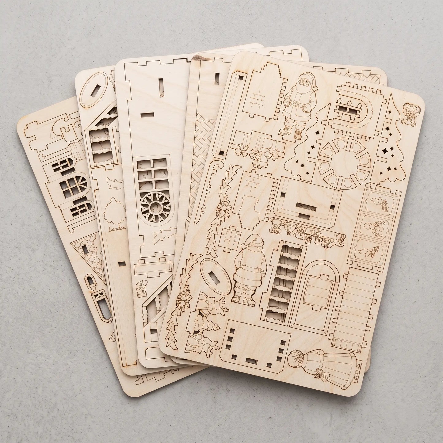 Multiple laser-cut plywood sheets created from compact SVG nesting layouts