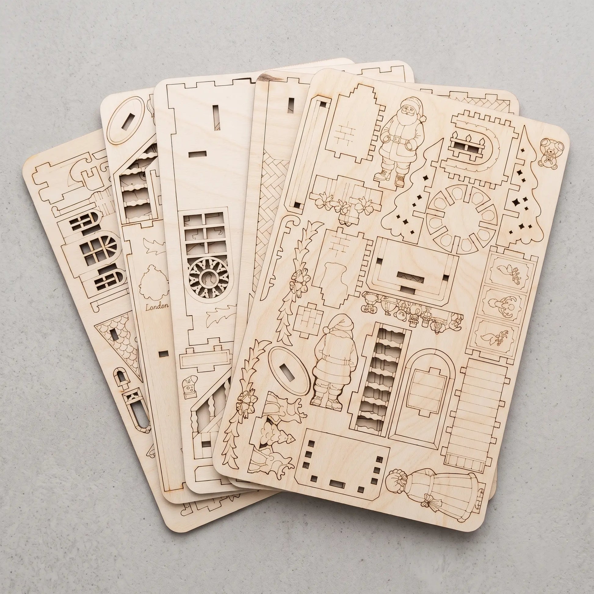 Multiple laser-cut plywood sheets created from compact SVG nesting layouts