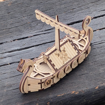 Top-down angle of the laser cut wooden Viking longship model, showing the deck layout, mast support, and layered construction