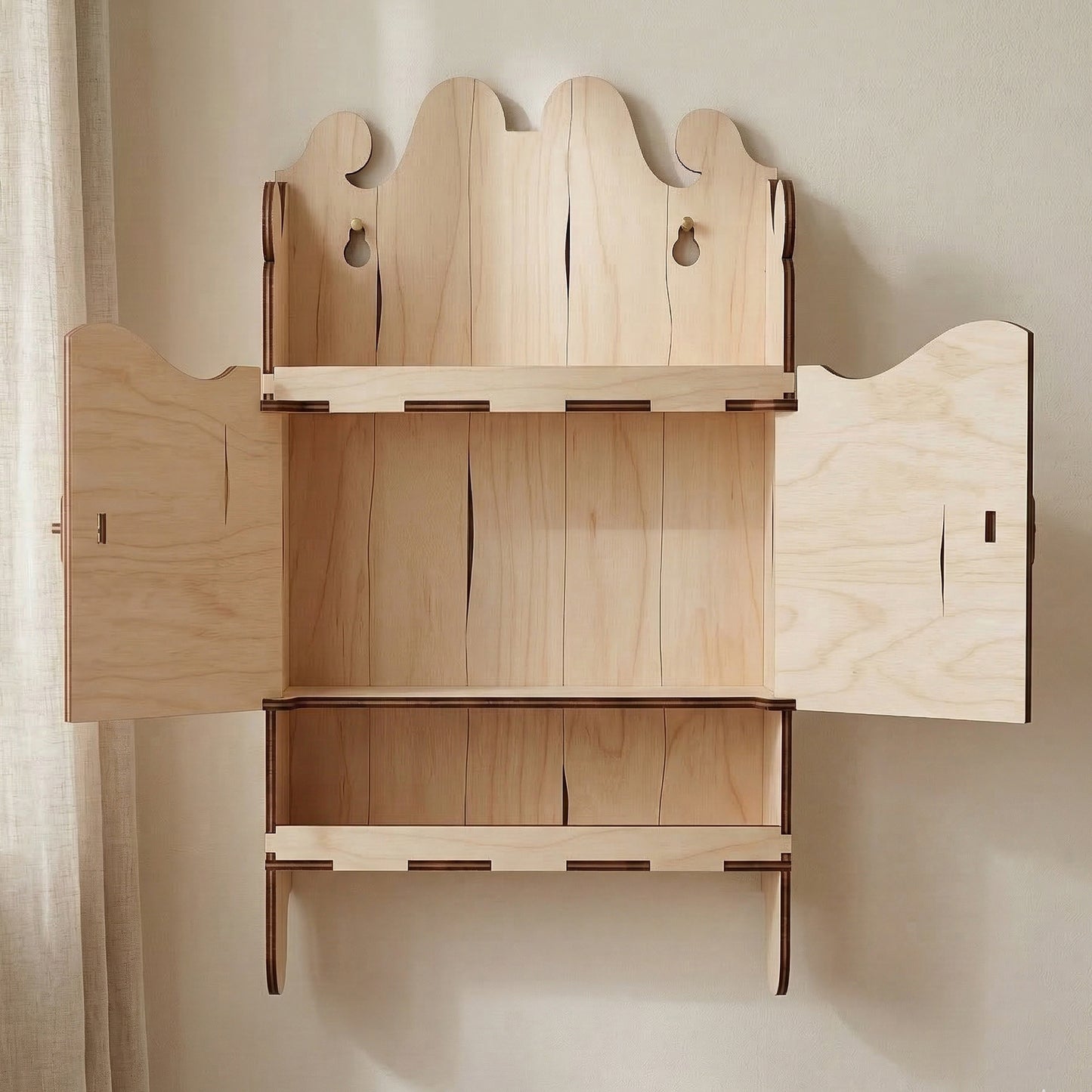 Open view of a laser cut plywood miniature wall shelf. Two doors are swung open to reveal the interior storage space. Crafted with precise interlocking joints and a decorative arched header, shown in a bright interior.