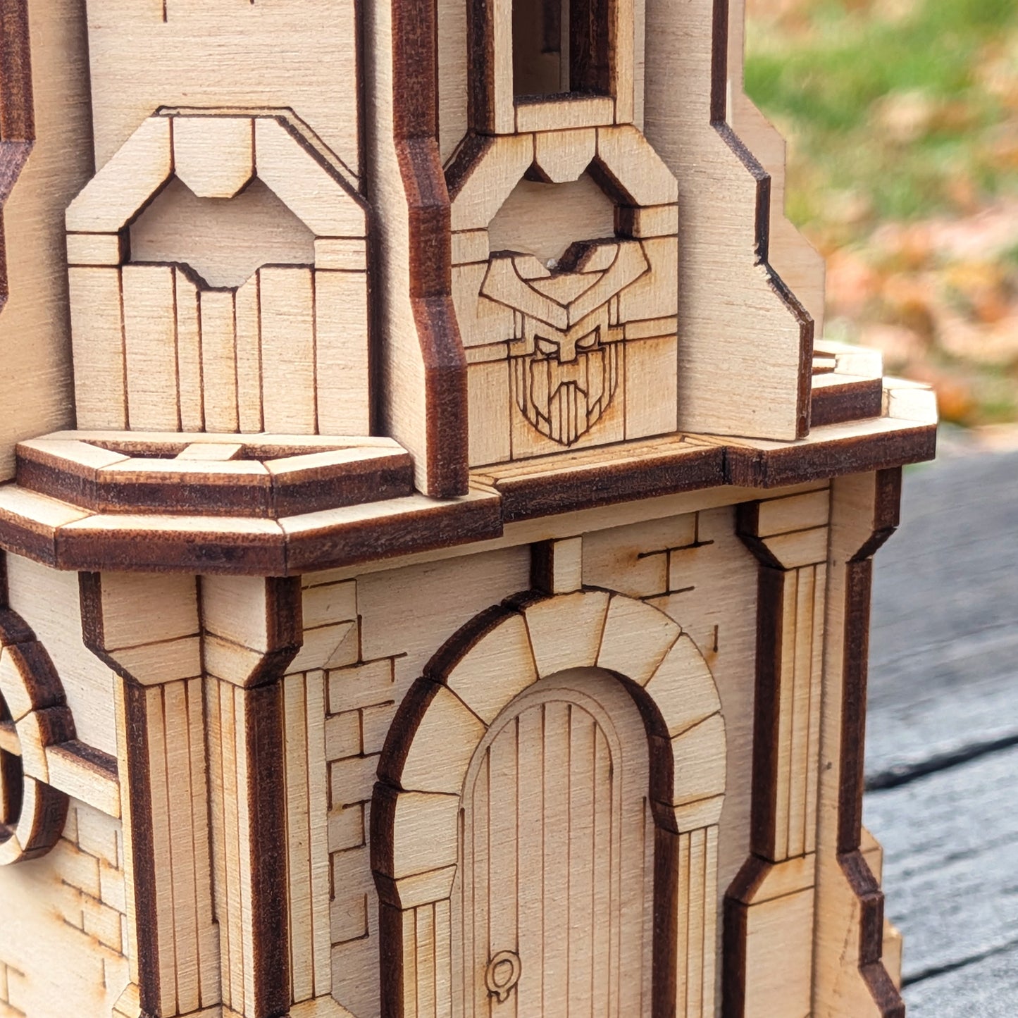 Close-up of a wooden laser cut model of a castle or similar structure with intricate details.