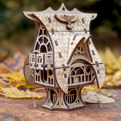 Front perspective view of an intricate miniature fairytale owl cottage on a pedestal, crafted from fine laser cut plywood.