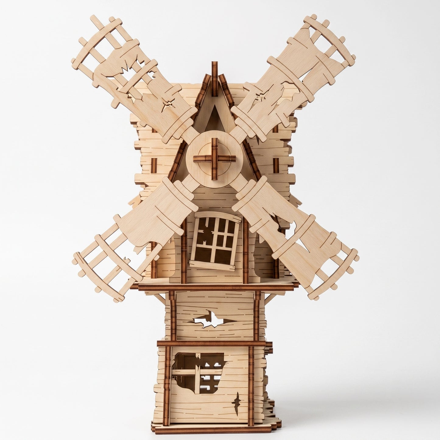 Front-facing view of a laser-cut birch plywood Halloween windmill model with spinning blades and dark burnt edges