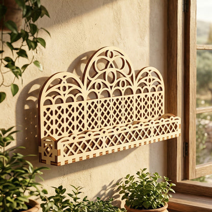A triple-arch laser-cut plywood window stand and planter box mounted on a wall. Features an intricate gothic-inspired lattice pattern and decorative scalloped trim. Wall-mounted in a bright, sunlit room, highlighting the natural wood grain and precision laser-etched edges.