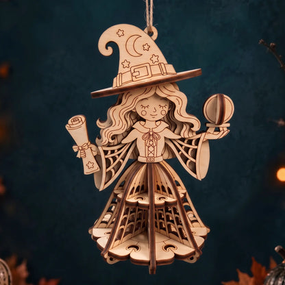 Hanging laser cut plywood witch figurine holding scroll and orb, featuring tiered cut-out 3D skirt on moody background.