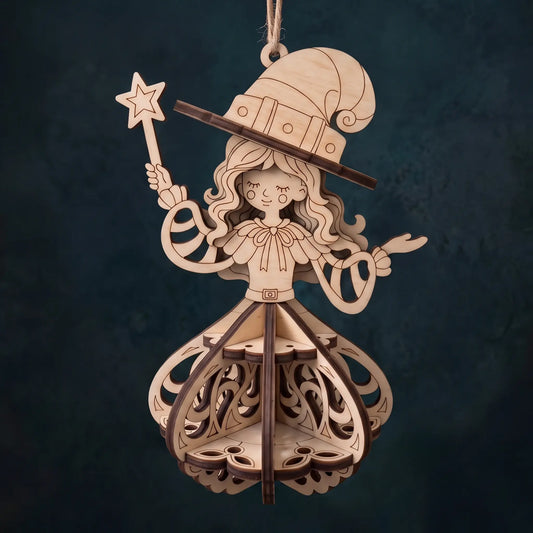 A laser-cut wooden hanging ornament shaped like a whimsical wizard or fairy, with a tall hat, star wand, and layered decorative body, shown against a dark textured background.