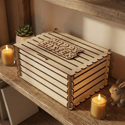 A rectangular crate-style gift box made of laser cut plywood with horizontal slats. The lid features a raised wooden "Happy Easter" sign. It is displayed on a wooden shelf next to candles, a small succulent, and a bunny figurine.